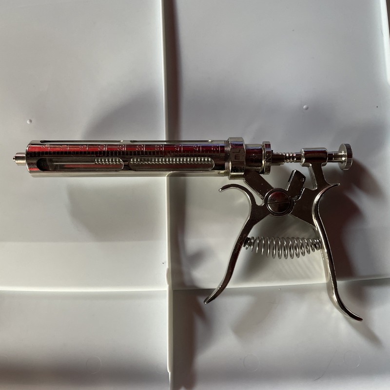 Vintage Metal syringe glass vial 50cc. Incomplete.