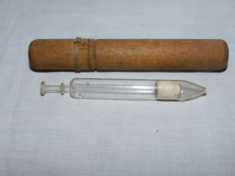 ANTIQUE CLEAR GLASS MEDICAL SURGICAL SYRINGE IN ORIGINAL WOOD TUBE HOLDER..